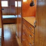 the inside of a house with wood flooring and drawers on both sides of the room