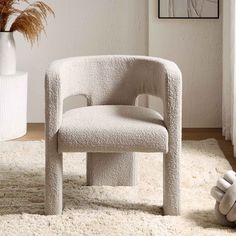 a white chair sitting on top of a shaggy rug