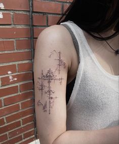 a woman with a cross tattoo on her arm