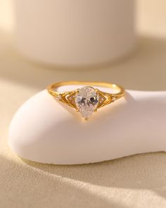 a gold ring sitting on top of a white object