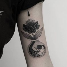 a black and white photo of a woman in a vase with flowers on her arm