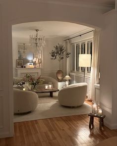 a living room filled with furniture and a chandelier