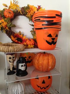 a shelf with pumpkins and decorations on it