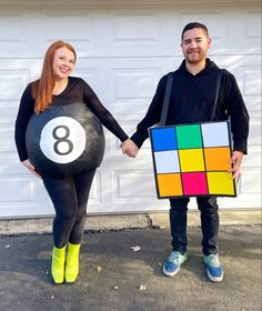 a man and woman holding hands with a rubik cube costume