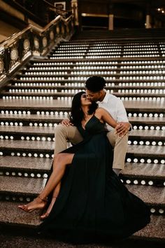 a man and woman sitting on some stairs