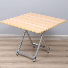 a wooden table sitting on top of a hard wood floor