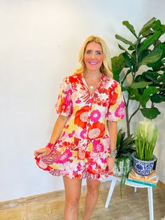 This flirty floral print mini is lightweight, lined, and features tiered ruffles with button closure down the front. Perfect for summer days, and when fall arrives, just throw on a pair of tall cowboy boots for a chic transition look. Ideal for brunch dates, outdoor festivals, or casual weekend strolls. PRODUCT FIT - TRUE TO SIZE MODEL DETAILS - BRENNA IS WEARING A SIZE EXTRA SMALL, 5'3" CAROLINE IS WEARING A SIZE LARGE, 5'10" BUST CIRCUMFERENCE - SMALL 37", MEDIUM 39”, LARGE 41” LENGTH -SMALL 3 Flirty Floral Print Mini Dress For Fall, Flirty Floral Mini Dress For Fall, Trendy Printed Mini Dress For Spring, Flirty Printed Mini Dress For Spring, Spring Flirty Printed Mini Dress, Flirty Printed Spring Mini Dress, Multicolor Ruffle Hem Mini Dress For Summer, Summer Multicolor Mini Dress With Ruffle Hem, Multicolor Summer Mini Dress With Ruffle Hem