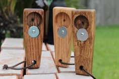 two wooden speakers sitting on top of bricks