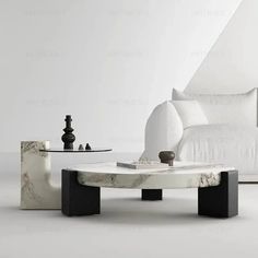 a marble coffee table with black legs and white walls in the background, next to a couch