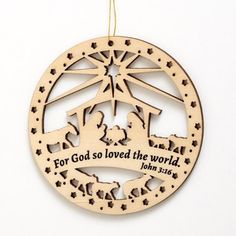 a wooden ornament with the words for god so loved the world