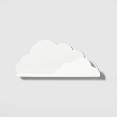 a white cloud shaped tray on a gray background with the shadow of it's top