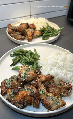 two plates with chicken, rice and asparagus on them next to each other