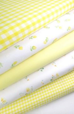 yellow and white fabrics stacked on top of each other