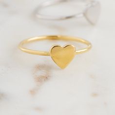 Beautiful, and dainty heart ring. ✿ Details ✿ ✤ Made of 925 Sterling Silver ✤ Available in 14k Gold or Rhodium Plated ✤ We use a THICK plating of 14k Gold for a piece that is sure to last years to come ✤ Nickel-free ✤ WILL NOT TURN FINGER GREEN! ✤ Available in Sizes 4, 5, 6, 7, 8, 9, or 10 ✤ Heart Measures 7 x 7 mm Stacking Rings Shown on Model: https://www.etsy.com/listing/739952471/dainty-diamond-stacking-eternity-ring?ref=shop_home_active_8&pro=1 https://www.etsy.com/listing/770233900/bra Heart Shaped Stackable Rings For Everyday, Everyday Stackable Heart Ring, Stackable Everyday Heart Ring, Gold Heart-shaped Stackable Midi Rings, Heart Shaped Stackable Rings For Valentine's Day, Gold Stackable Heart Midi Rings, Stackable Heart Ring For Everyday And Valentine's Day, Everyday Stackable Heart Ring For Valentine's Day, Everyday Stackable Rings For Valentine's Day