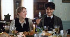 a man and woman sitting at a dinner table