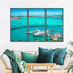 a living room filled with furniture next to a wall mounted art print on the wall