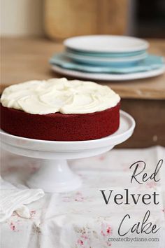 a red velvet cake sitting on top of a white cake plate