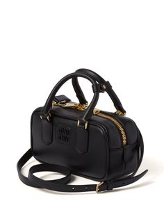 Miu Miu Logo Plaque Mini Bag - Farfetch Luxury Shoulder Bag With Logo Plaque And Top Handle, Luxury Shoulder Bag With Top Handle And Logo Plaque, Black Modern Bag With Gold-tone Logo Plaque, Modern Black Bag With Gold-tone Logo Plaque, Chic Bags With Logo Plaque And Top Handle, Chic Top Handle Bag With Logo Plaque, Formal Top Handle Shoulder Bag With Logo Plaque, Modern Gold Bag With Logo Plaque, Modern Gold Bags With Logo Plaque