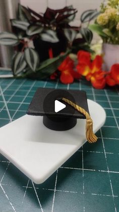 a graduation cap sitting on top of a white plate