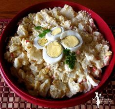 a red bowl filled with food on top of a table