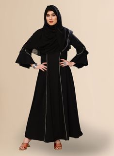 This elegant Pakistani Abaya for women, designed for the modern woman seeking both style and modesty. Crafted from high-quality polyester BSY fabric, this black abaya exudes sophistication and comfort. Its full length design abaya ensures modest coverage, while the fashion sleeves add a touch of contemporary flair. Complete with a nakab for added privacy, this abaya is perfect for any occasion. Pair it with your favorite sandals for a chic and effortless look. Long Black Abaya For Eid, Modest Black Khimar, Black Long Khimar For Eid, Black Long Sleeve Khimar With Dabka, Black Long Sleeve Hijab For Eid, Black Long Abaya, Long Sleeve Black Khimar For Eid, Black Long Sleeve Khimar For Eid, Black Maxi Abaya For Eid