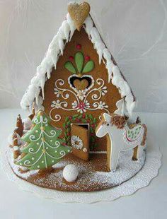 a gingerbread house decorated with icing and decorations