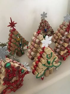 several wine cork christmas trees on a shelf