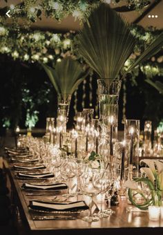 a long table is set with candles and place settings