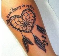 a woman's arm with a dream catcher tattoo on it