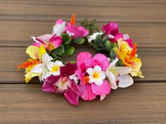 a wreath made out of flowers sitting on top of a wooden table