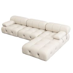 a white leather sectional sofa with buttons on the back