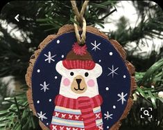 a wooden ornament with a bear wearing a hat and scarf