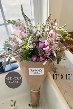 a bouquet of flowers sitting on top of a window sill next to a sign