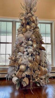 a christmas tree decorated with gold and silver ornaments