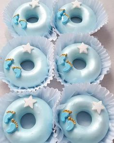 six donuts with blue frosting and white stars on them