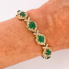 "An opulent estate mint condition circa 1980 fine emerald and diamond bracelet in solid 14K yellow gold.  This divine high carat luxurious bracelet is of exceptional quality. The gorgeous design of this sinuous bracelet has alternating links each set with a large faceted emerald followed by a fine cabochon emerald each precious colored gem entirely surrounded by a border of fine white diamonds.  The secure box clasp is hidden inside a diamond set link. This makes the bracelet look like an endles Luxurious Bracelet, Emerald Tennis Bracelet, Halo Bracelet, Bracelet Emerald, Emerald Halo, Emerald Cabochon, Emerald Style, Christmas Engagement, Emerald Bracelet