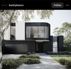 a black and white house surrounded by trees