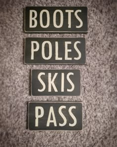 three signs that say boots, poles, skis, and pass on the floor