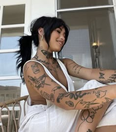 a woman with many tattoos on her body