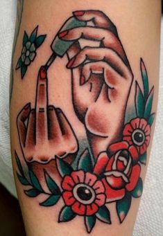 a woman's arm with flowers and two hands on it