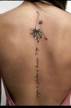 the back of a woman's neck with a tattoo on it