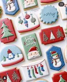 decorated christmas cookies are displayed on a table