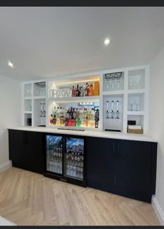 an empty bar with many bottles on the shelves