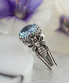 Looking for a stunning gift for your loved ones? This exquisite silver filigree queen bee detailed women's cocktail ring is a perfect choice. With its intricate design and stunning face-up look, this ring is sure to grab everyone's attention. The ring features a 10 mm double-side faceted checkerboard round-cut blue topaz gemstone and 0.47" / 12.00 mm face size, adding to its beauty and elegance. This gorgeous piece comes with a velvet pouch, silver polish cloth, and a luxurious gift box, making Playful Jewelry, Silver Cocktail, Silver Polish, Blue Topaz Gemstone, Art Women, Sterling Silver Filigree, Box Making, Filigree Design, Bee Design