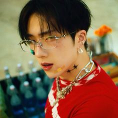 a young man with glasses and piercings on his neck