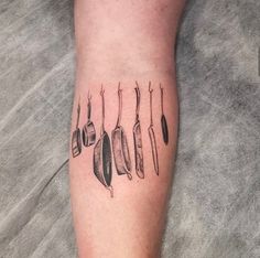 a tattoo with knives and spoons on it