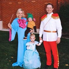 a man and woman in costumes standing next to a baby