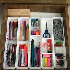 the drawers are organized with pens, pencils, markers and other office supplies in them