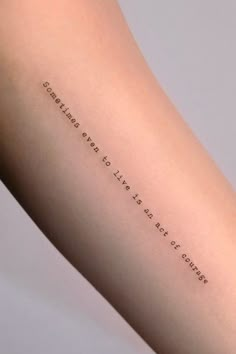 a woman's arm with a quote on it