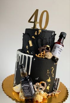 a black cake with gold numbers and decorations